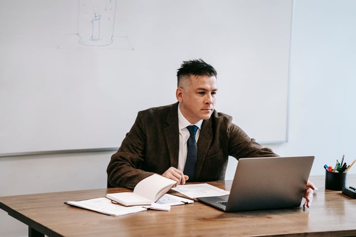 teacher working on a laptop